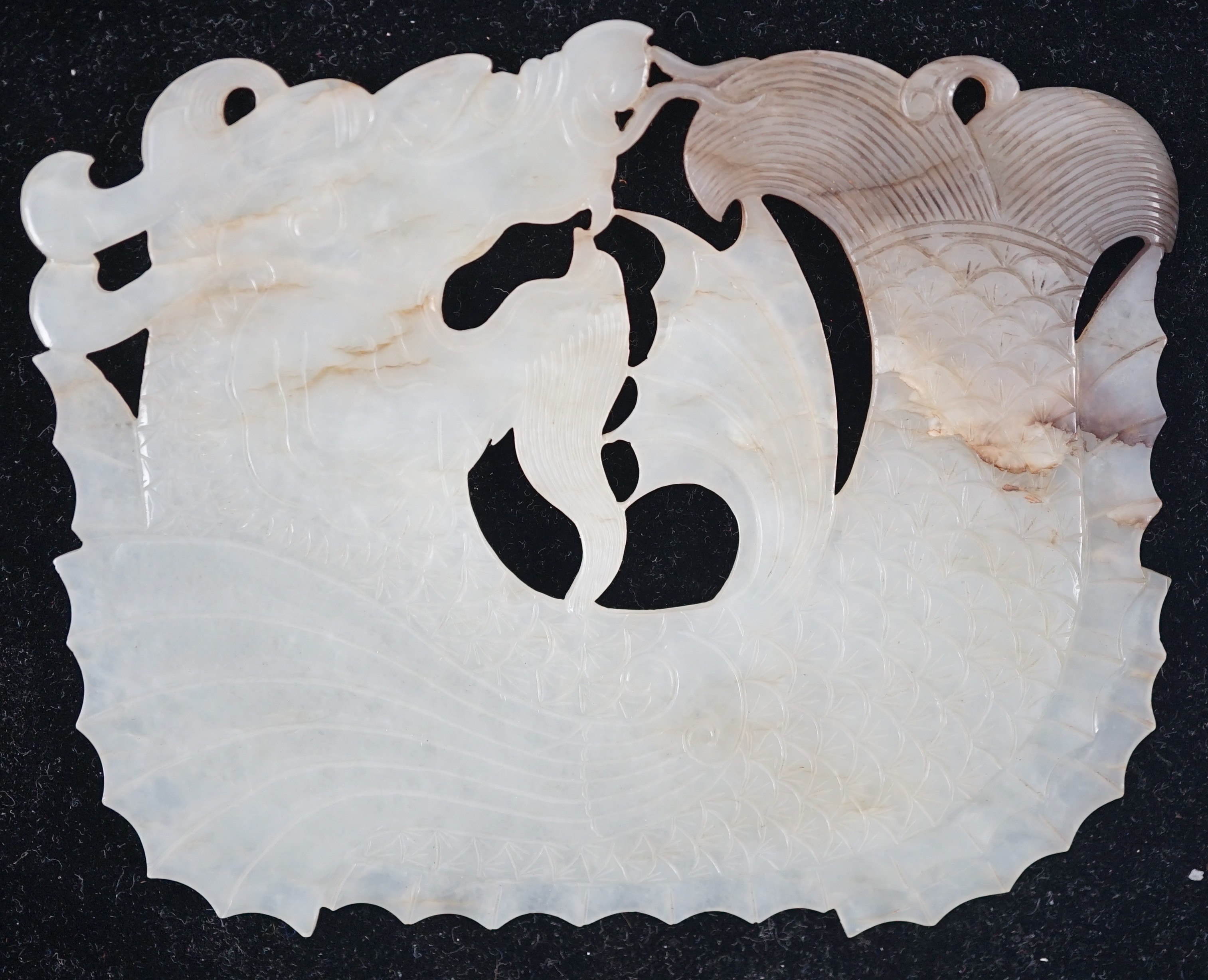 A Chinese late Ming white and grey jade ‘dragon-fish’ plaque, 17th century, 11.7cm wide, 9.3cm high